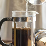 Organic coffee being brewed in a French press