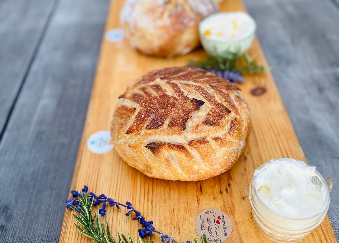 Fresh sourdough boules with whipped homemade butter at Daily Bread Co.