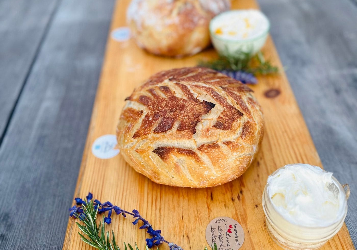 Fresh sourdough boules with whipped homemade butter at Daily Bread Co.