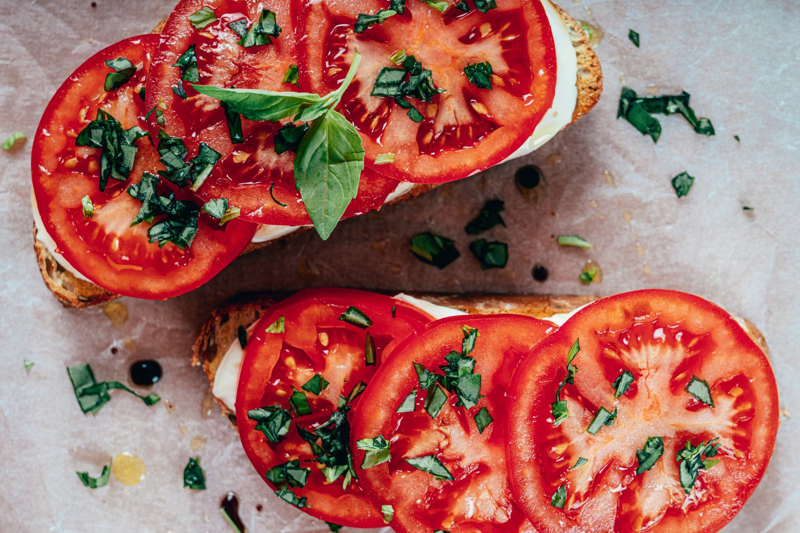 Tomato basil toast with whipped cream cheese, egg, and fresh basil