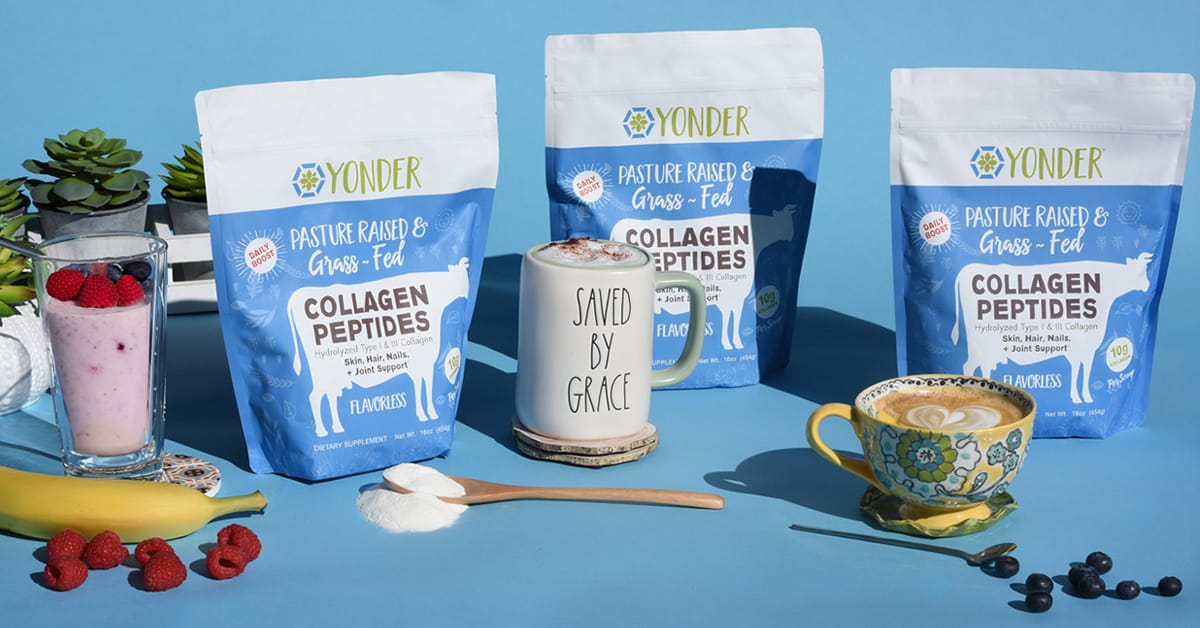 Three bags of Yonder grass-fed collagen peptides with a berry smoothie and a cup of coffee